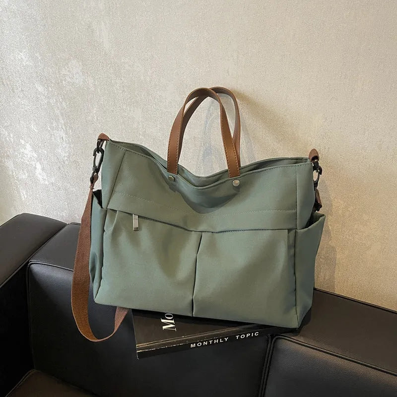 Nylon crossbody tote bag in black grey white green colours showing dimensions 39x28cm