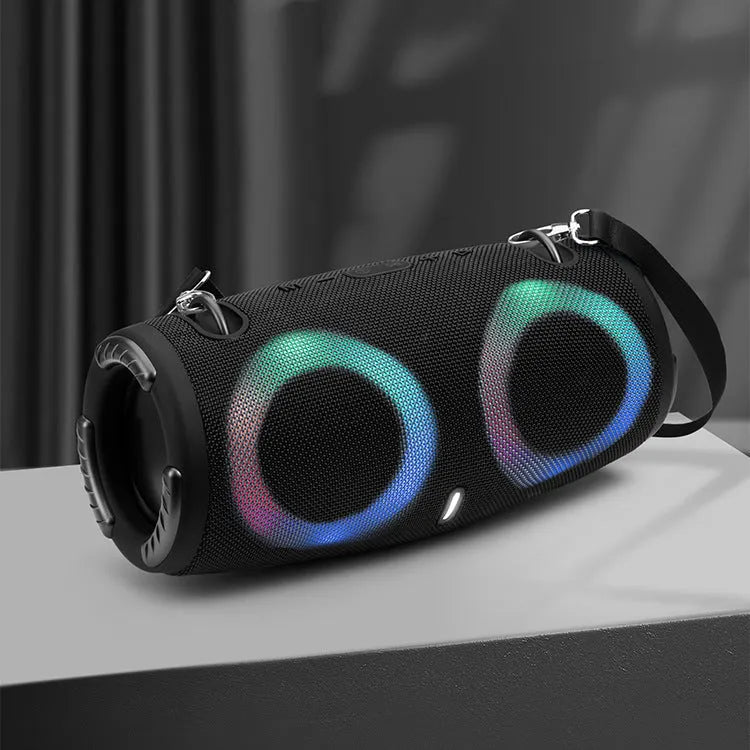 Cylindrical War Drum Bluetooth speaker with coloured RGB lights in a waterproof outdoor setting.