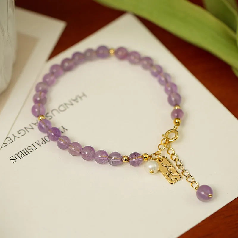 Women's natural crystal bracelet with lavender amethyst stones and animal zodiac design