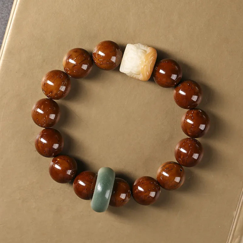 Hand-woven 13mm round bead bracelet with artistic lion designs in ivory nut, sandalwood or yellow gradient bodhi colours