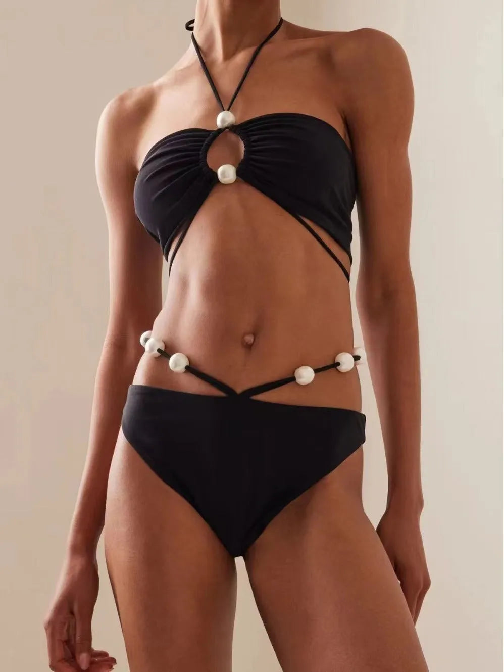 Black women's two-piece bikini swimsuit with lace-up front detail on the top.