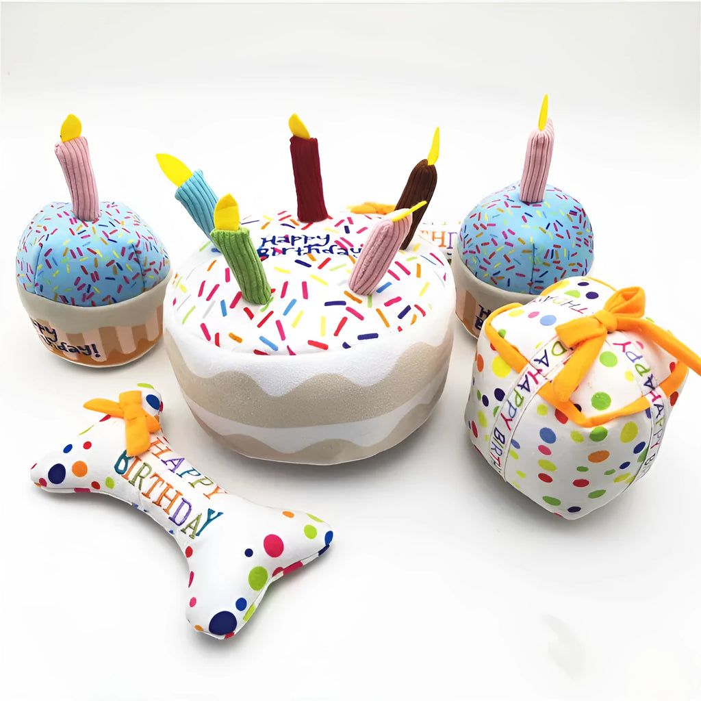 Four-piece dog birthday cake plush toy set including big cake, small cake, gift box, and bone on white background