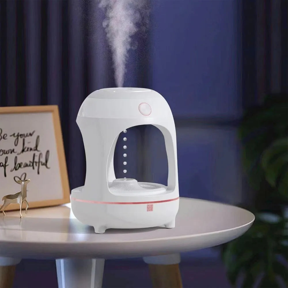 Rose gold and white columnar humidifier with levitating water drops and LED lighting on desk