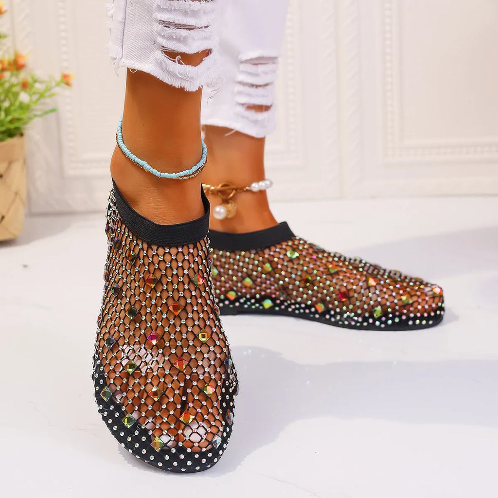 Women's flat mesh sandals with colourful rhinestone detail on a white background.