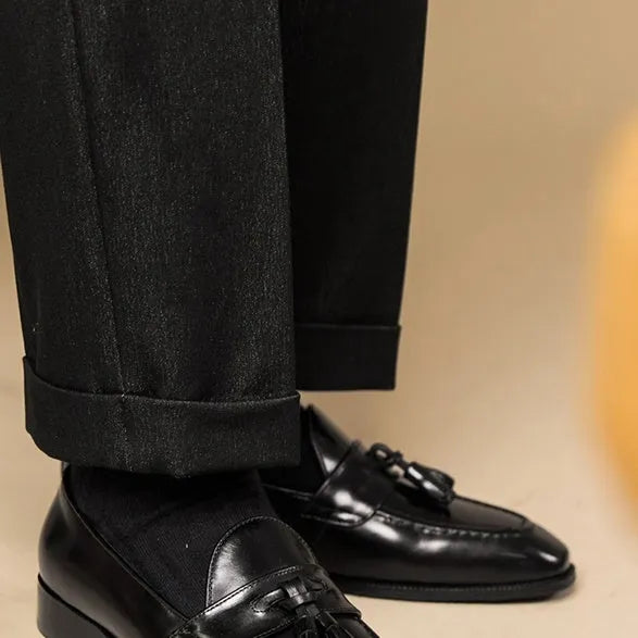 British-style leather tassel loafers in black or brown with polished uppers and traditional tassel detailing