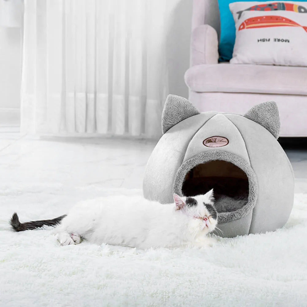 Grey enclosed cat sofa bed with a round entrance hole, showing a soft plush interior and removable cushion.