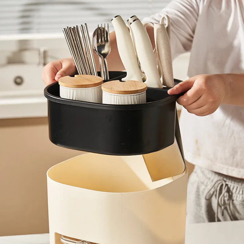 White rotating kitchen storage bucket with four compartments for cutlery and a separate spice box organiser.