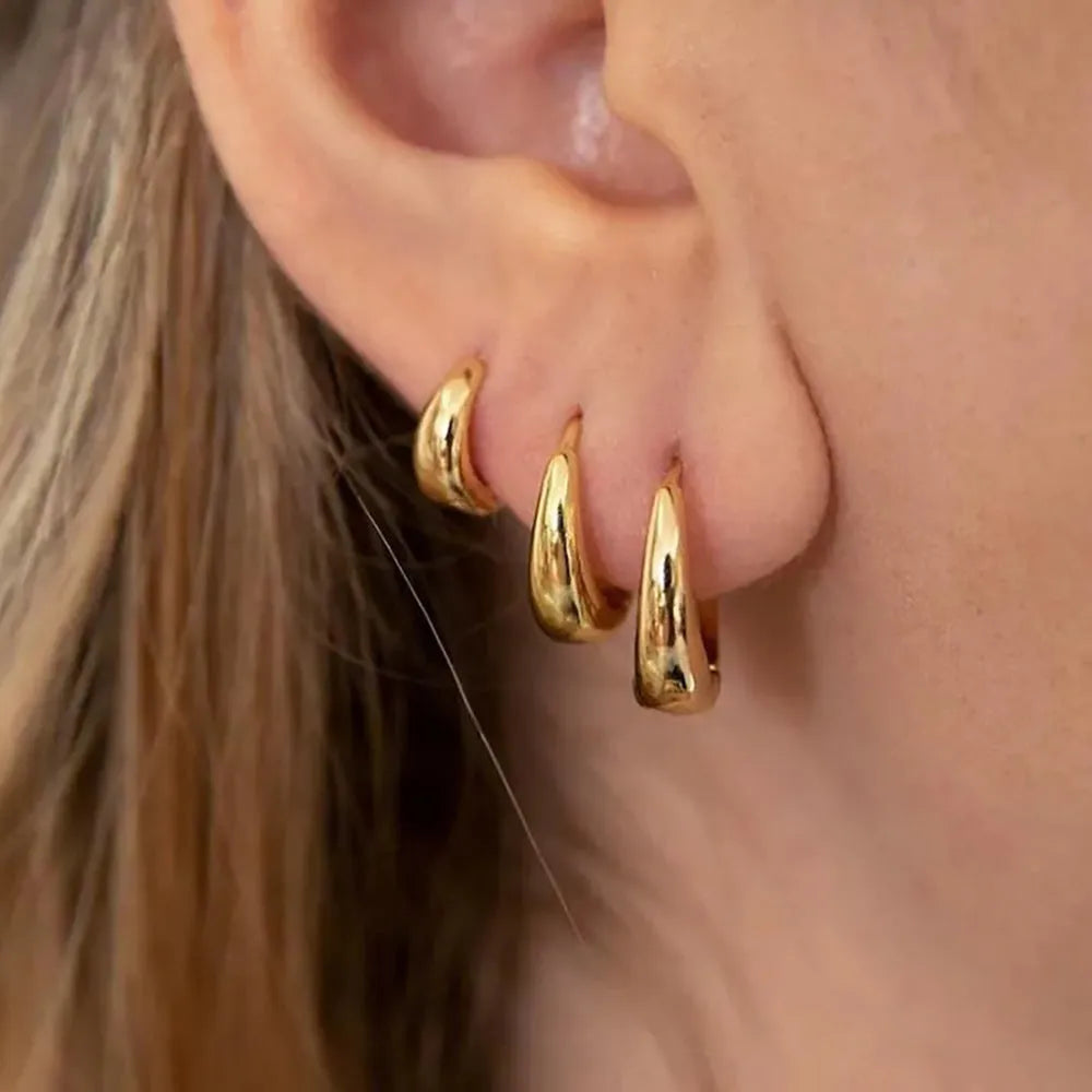 Geometric copper earring set of 3 glossy gold electroplated round shape earrings on display