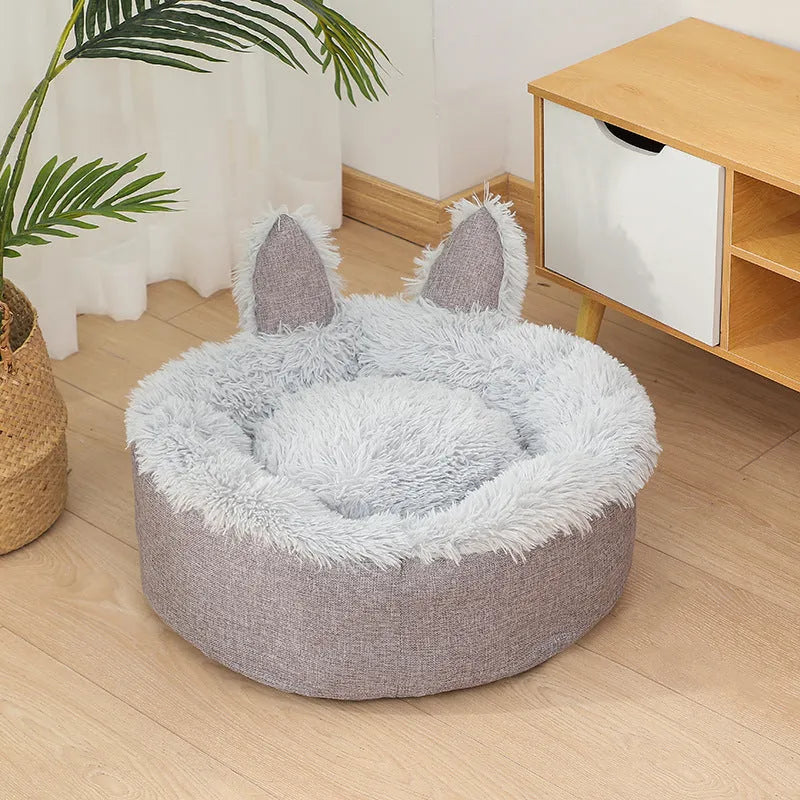Round plush faux fur cat bed with raised sides in blue colour showing soft texture