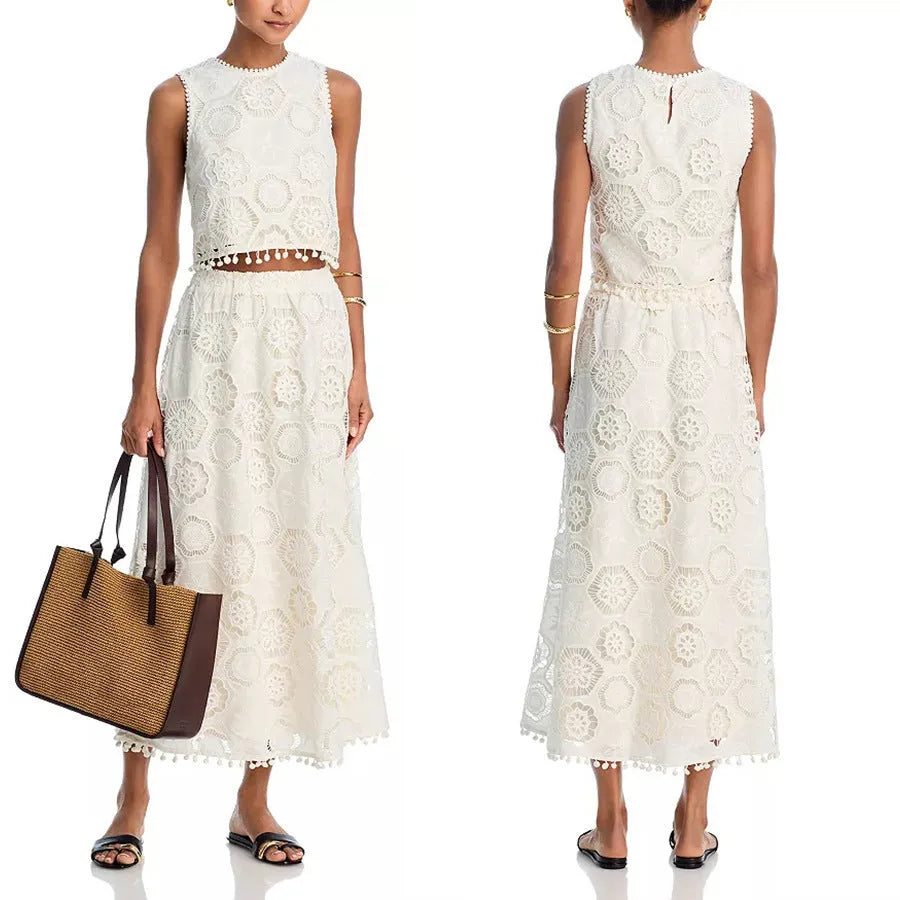 White women's sleeveless top and long skirt set with intricate embroidered retro art design detail.