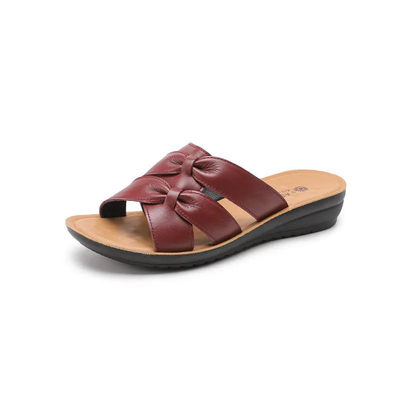 Beige cowhide women's slipper sandals with a non-slip sole, shown from the side.