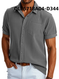 Man wearing a loose-fitting black and white printed short sleeve lapel shirt made of polyester.