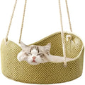 Green rattan cat hammock with cotton ropes and metal hooks, shown hanging.