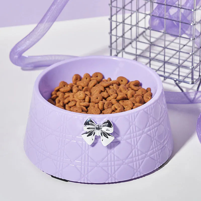 Diamond pattern pet feeding bowl with a bowknot decoration in black, purple or white with a pink or silver bow.
