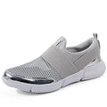 Blue low-top women's casual sneakers with mesh inside on a hard floor surface