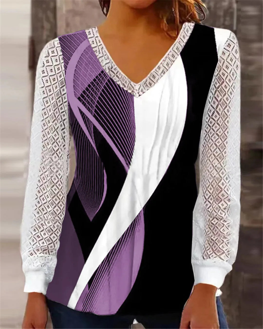 Women's loose purple V-neck lace top with long sleeves on a hanger.