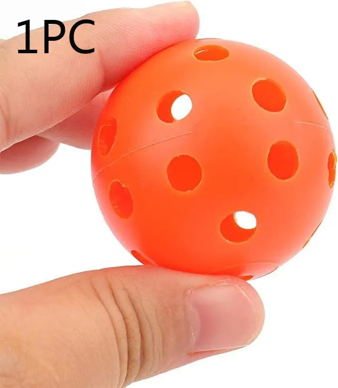 Multi-colour golf practice balls in red, orange, blue, green, white, and yellow shown in a net bag.