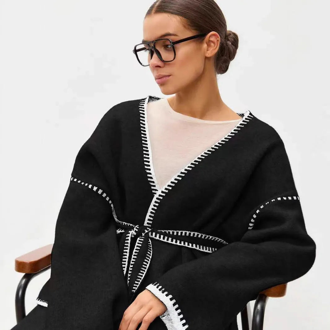 Loose lace-up knitted cardigan in camel colour, showing mid-length fit and long sleeves.