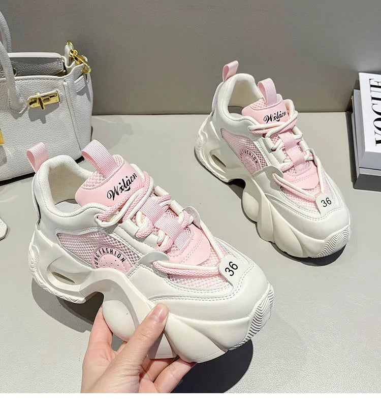 Women's beige casual sneakers with a thick sole, cross strap, and mesh lining on a white background.