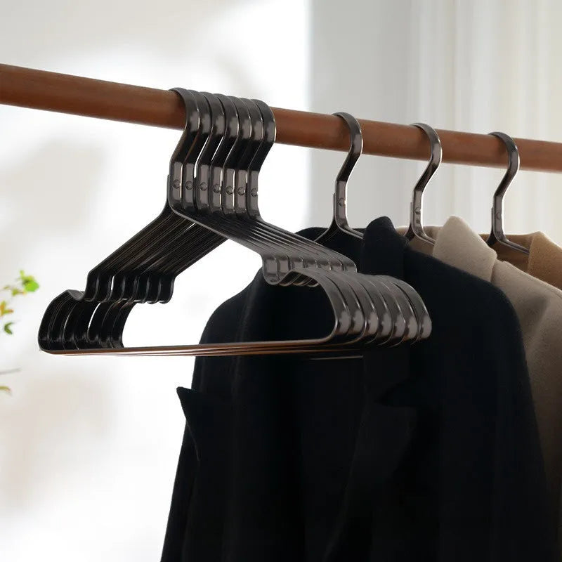 Elegant black non-slip clothes hanger for shirts, trousers and ties on a rail.