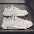 Men's casual white flat shoes with round toe and shallow mouth design on a plain background