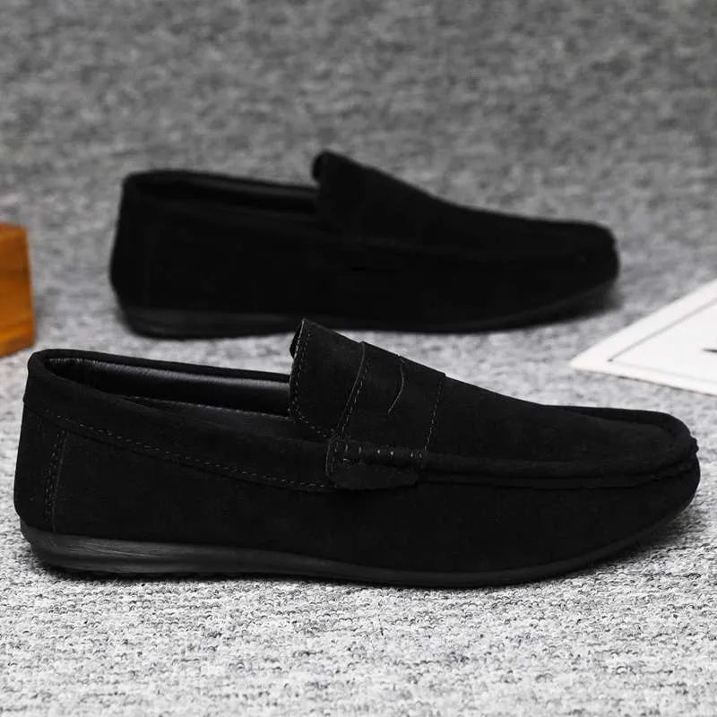 Men's black slip-on shoes with round toe, grape particle detail, and rubber sole.