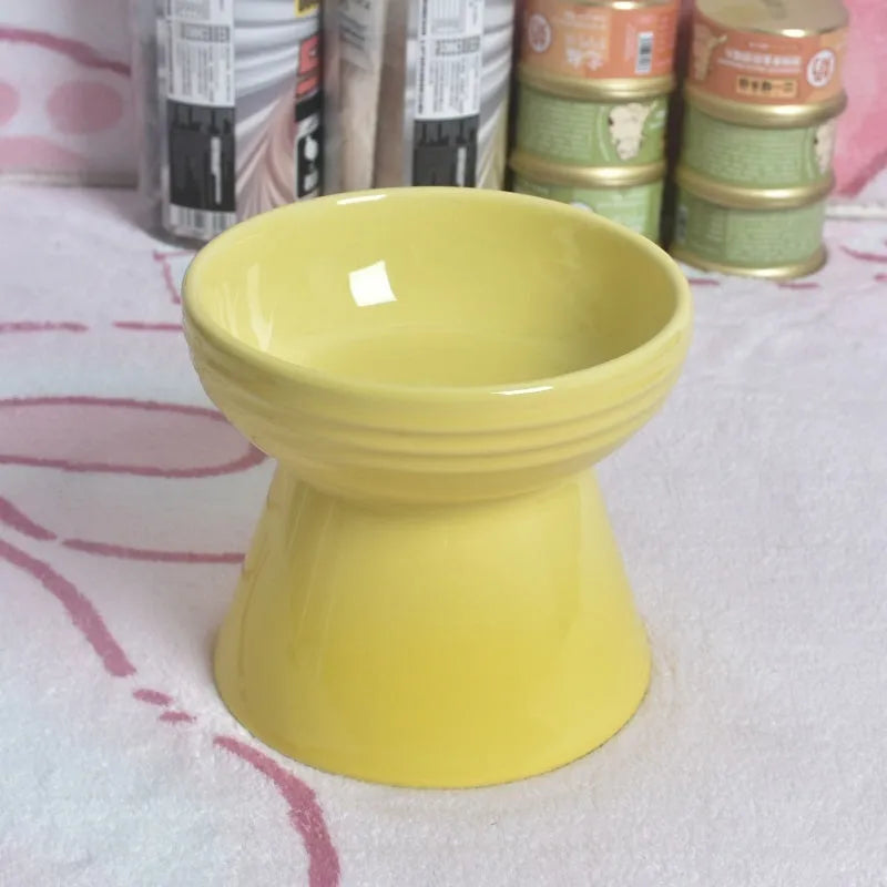 White ceramic pet bowl with a high foot base and wide, shallow eating area for dogs and cats