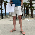 Men's straight-leg casual shorts in solid black, white, or khaki colour made from polyester fabric.