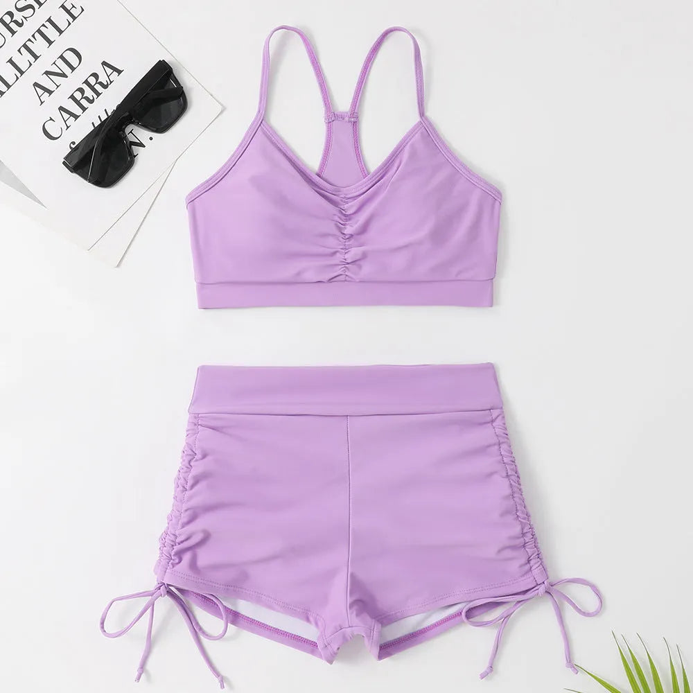 Purple high-waisted split bikini swimsuit for women on a mannequin.