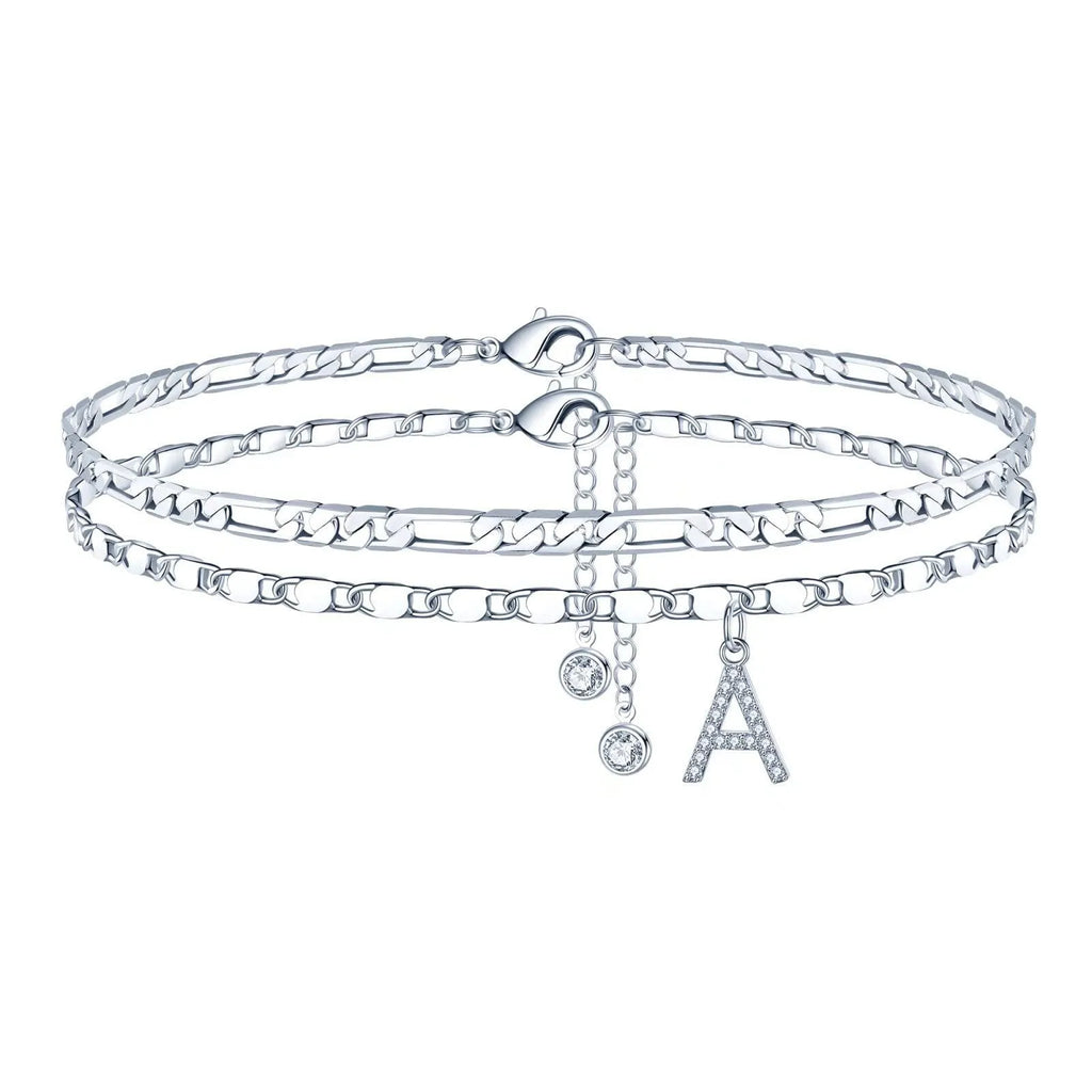 Silver-coloured copper anklet with a double-circle bead featuring a modelled letter charm.