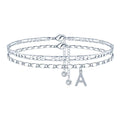 Silver-coloured copper anklet with a double-circle bead featuring a modelled letter charm.
