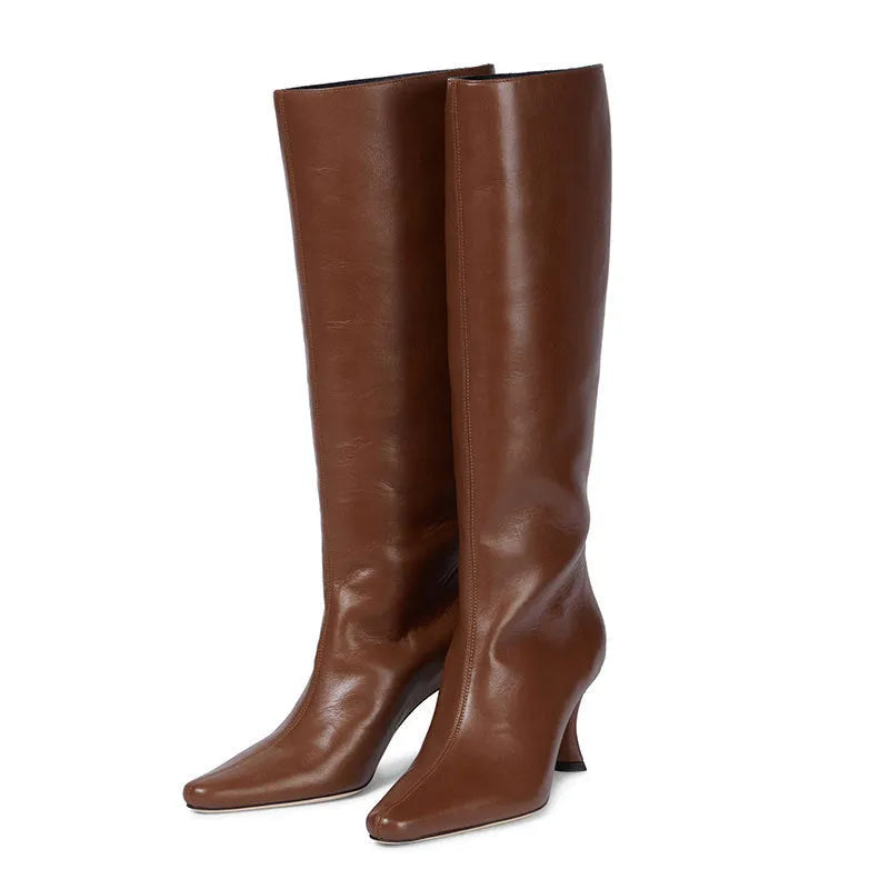 Women's black square toe cowboy boots with a block heel on a white background