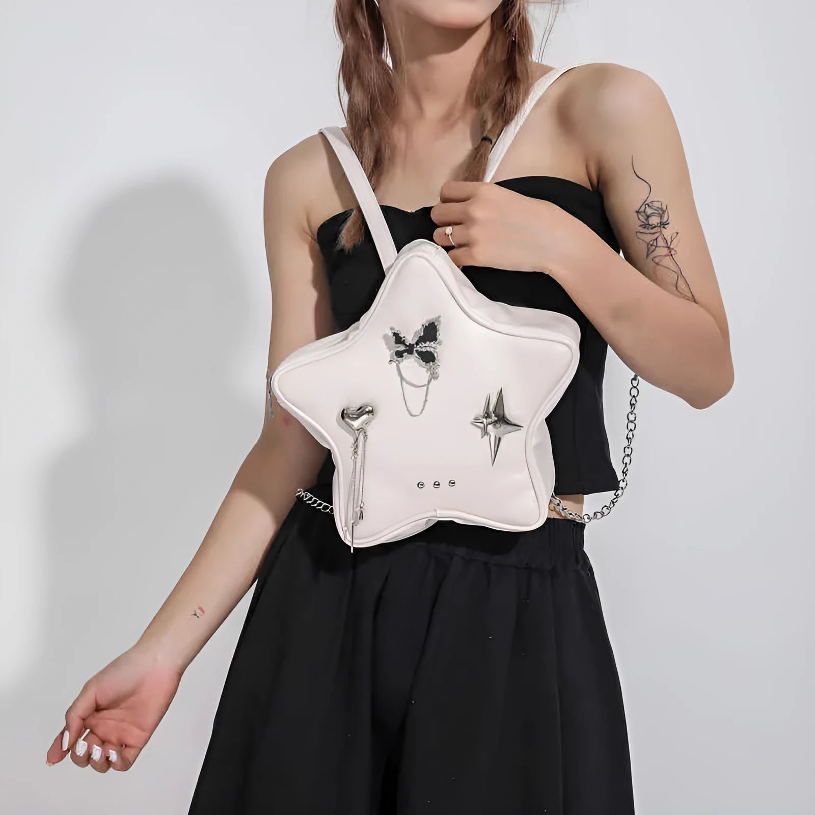 Soft PU leather women's mini backpack in black, shown being worn cross-body.