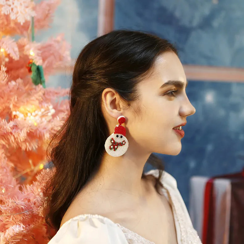 White acrylic snowman bead earrings on a white background, geometric shape, one pair shown