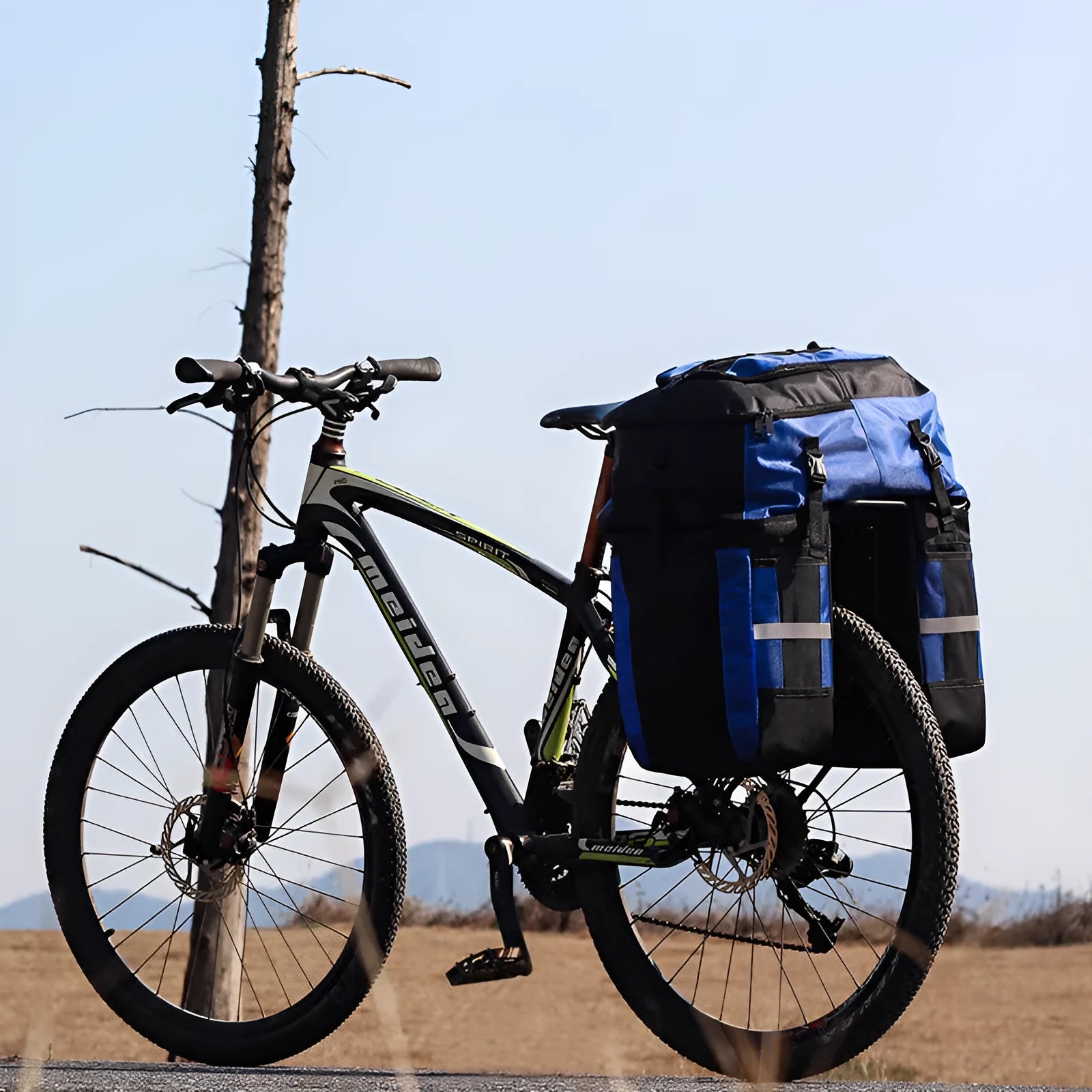 Rhinoceros large green bicycle rear pannier bag mounted on a bike rack for touring.