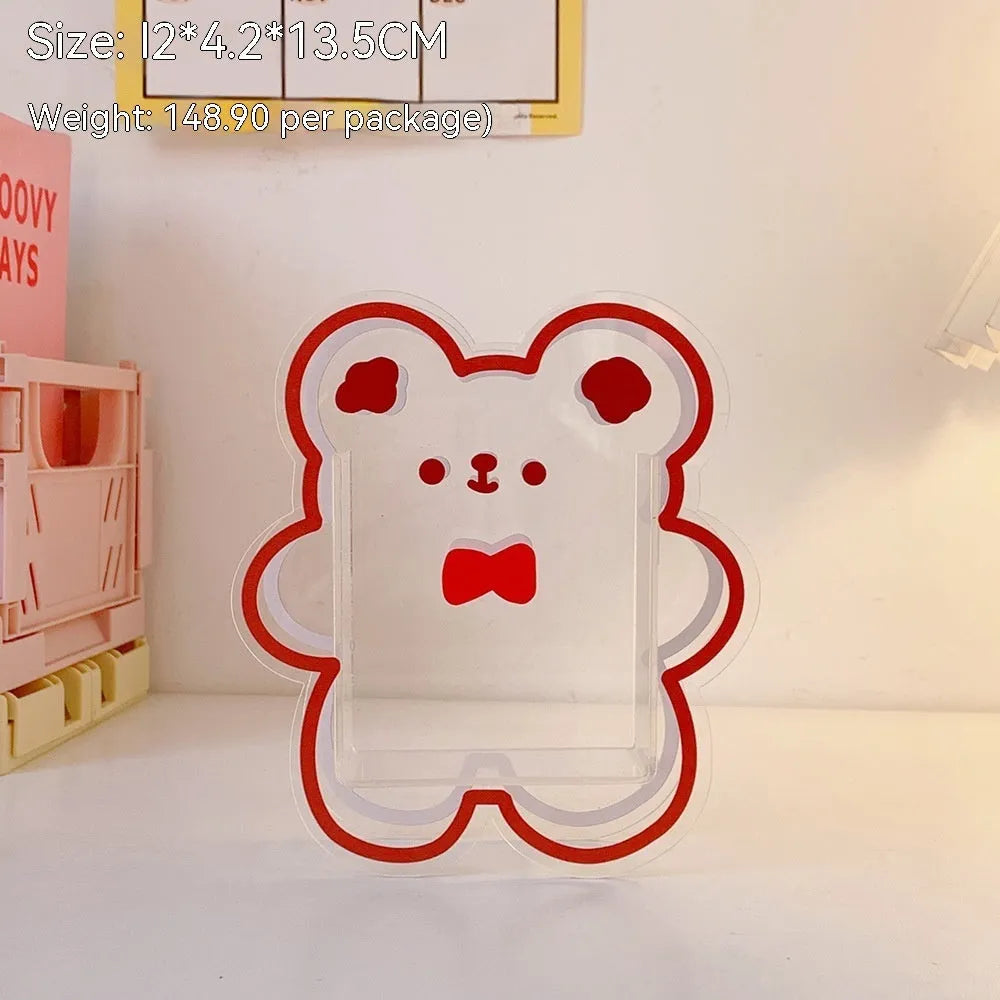 Clear square acrylic storage box with a colourful printed lid featuring a cute design, shown holding pens and stationery.