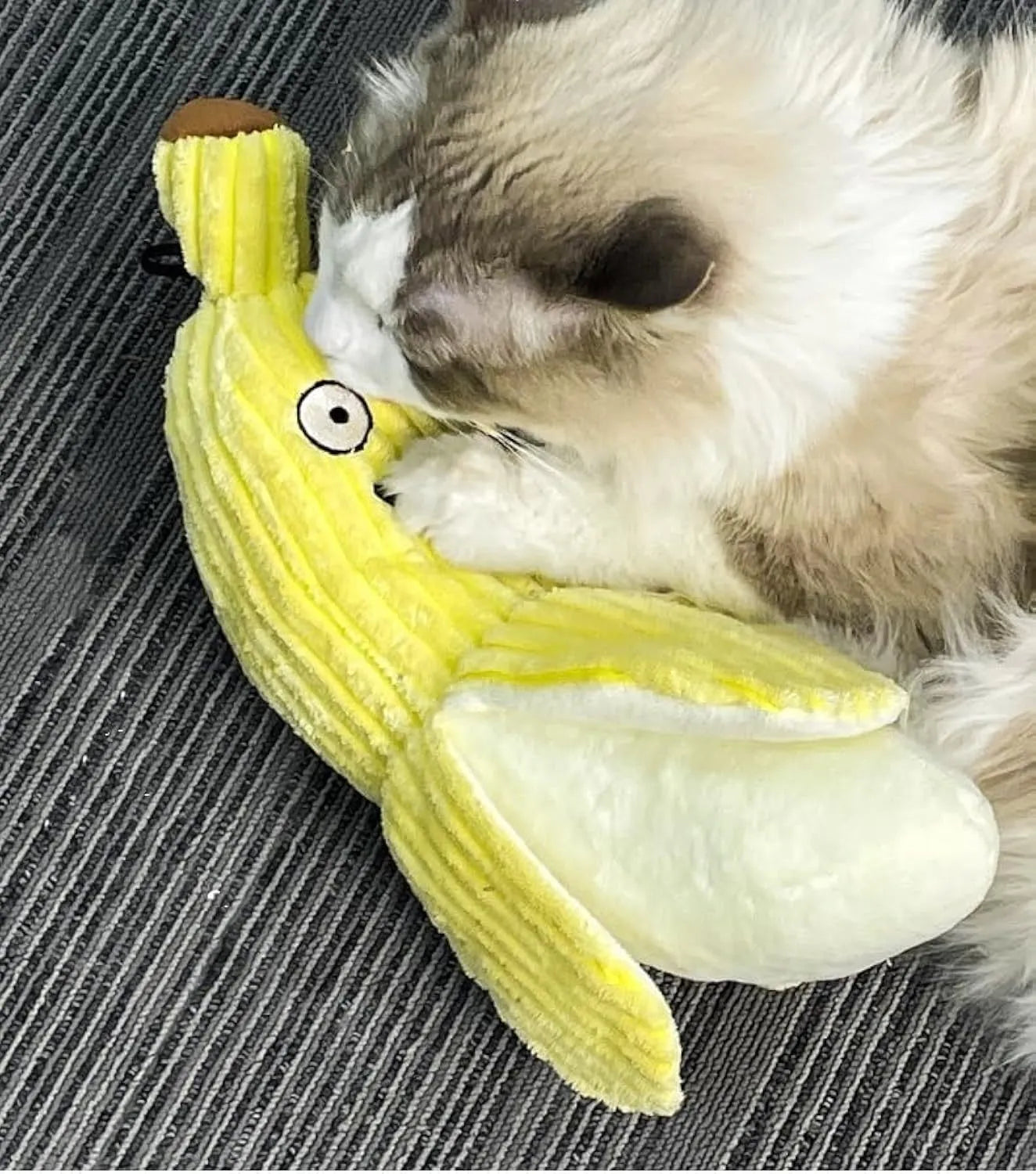 Yellow banana-shaped plush cat toy with a green tip and a textured velvet strip.