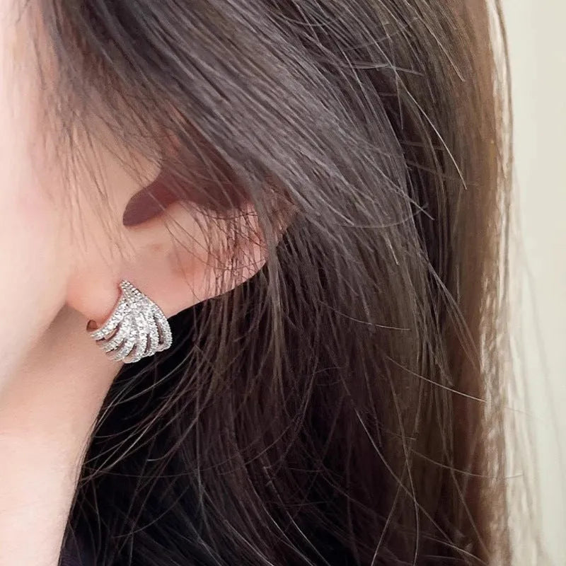 Geometric platinum-coloured zircon earrings for women on a white background.