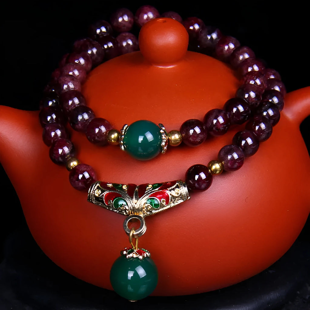 Natural garnet bracelet with 7mm beads and double-ring clasp for women, showing ordinary and upgraded quality options