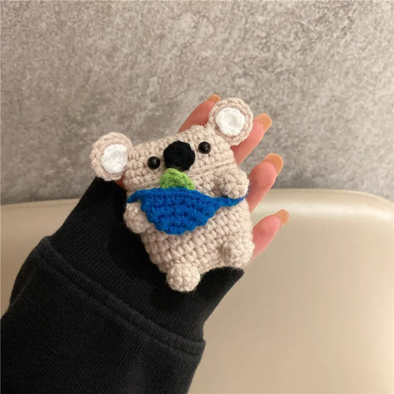 Hand-knitted grey koala bear design cover on a white Airpods case.