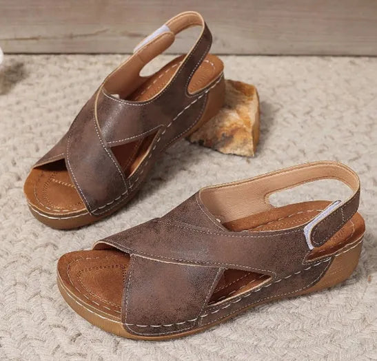 Women's brown Roman platform sandals with a skirt detail and velcro strap on a 1cm rubber sole.
