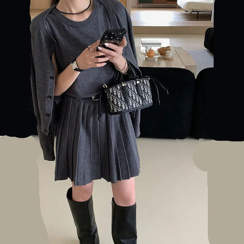 Women's grey Art Retro knitted set with 3D pattern, featuring a pleated midi skirt and long-sleeve cardigan.