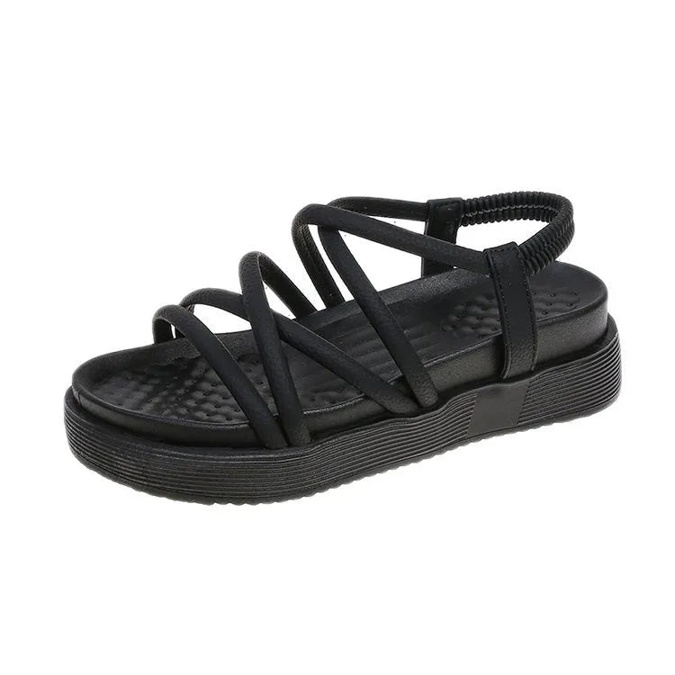 Women's black roman style platform sandals with straps on a white background.