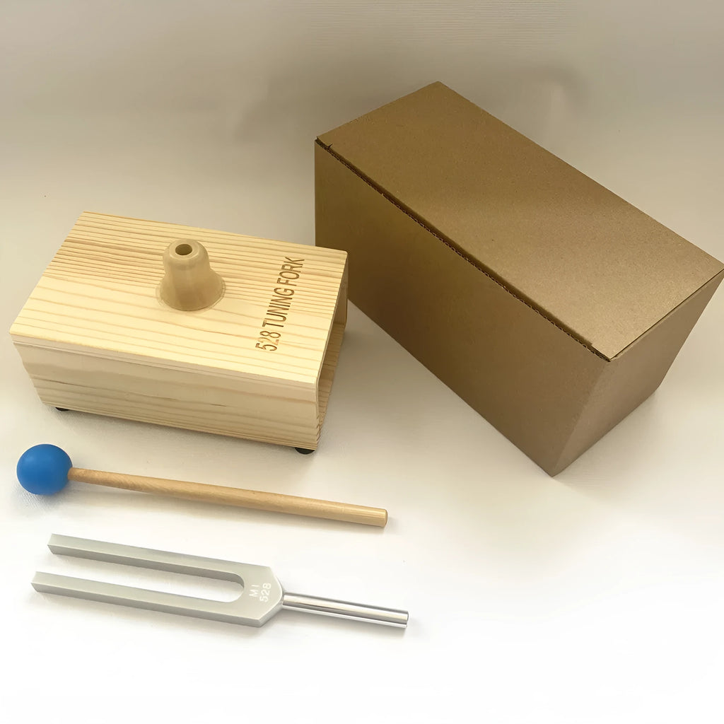 Aluminium alloy 432Hz tuning fork and speaker set on a kraft paper box.