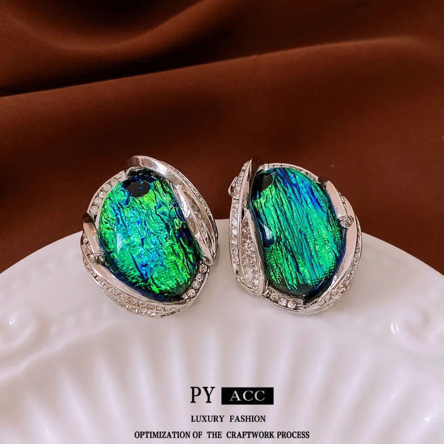 Silver resin stud earrings with rhinestone encrusting and irregular retro shape in silver needle green