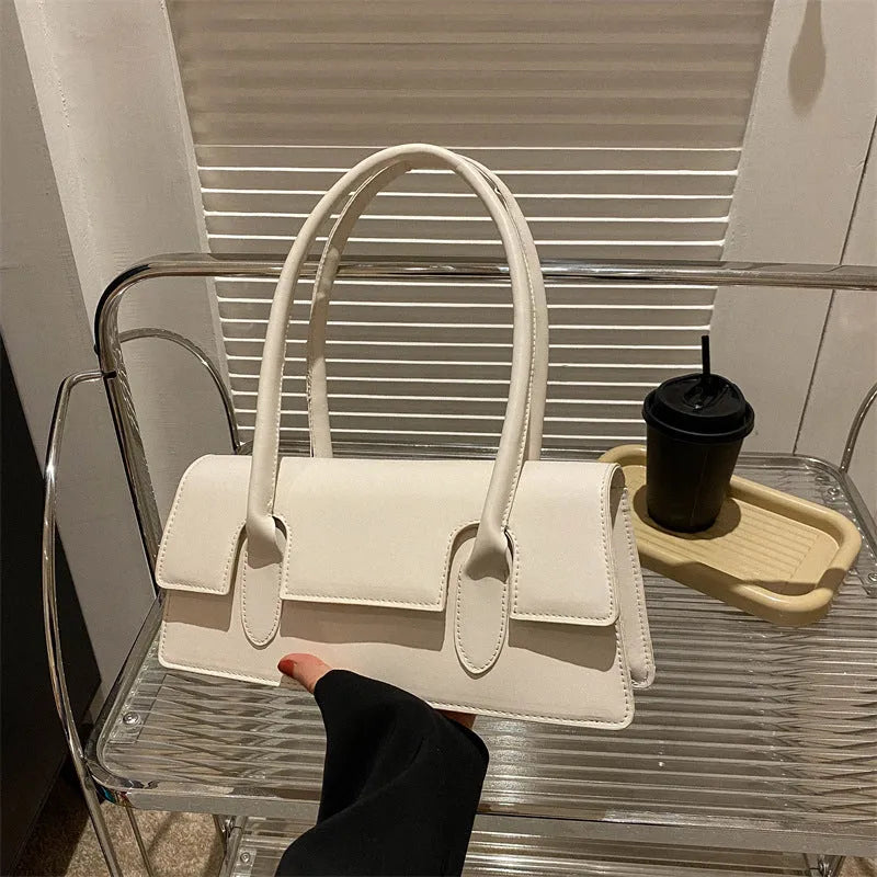 Women's small square shoulder bag in PU leather showing horizontal design with stitching details