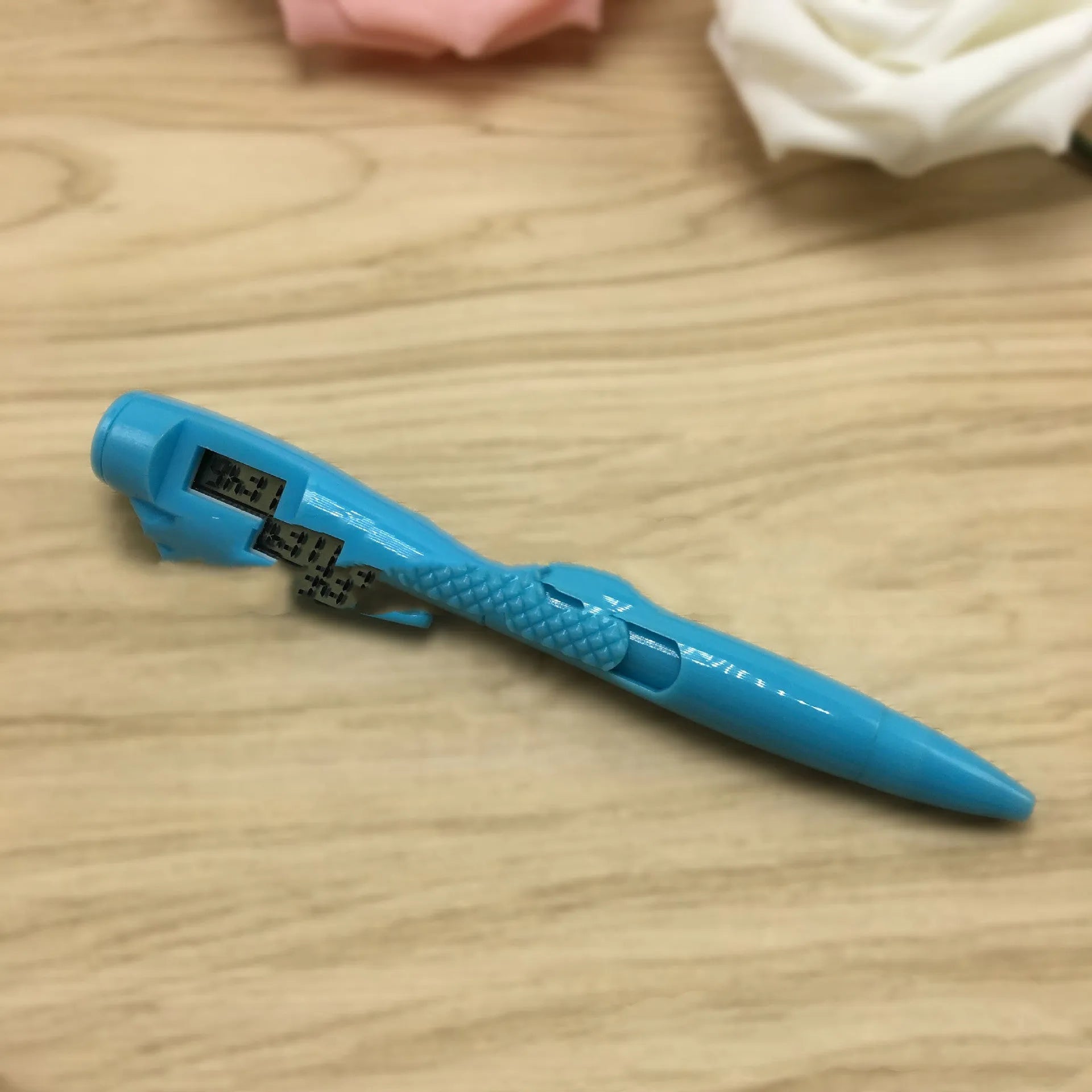 Electronic watch test ballpoint pen with plastic shell in a colour option, on a plain background