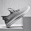Men's casual shoes with black flying weave upper, rubber sole, and front tie lacing