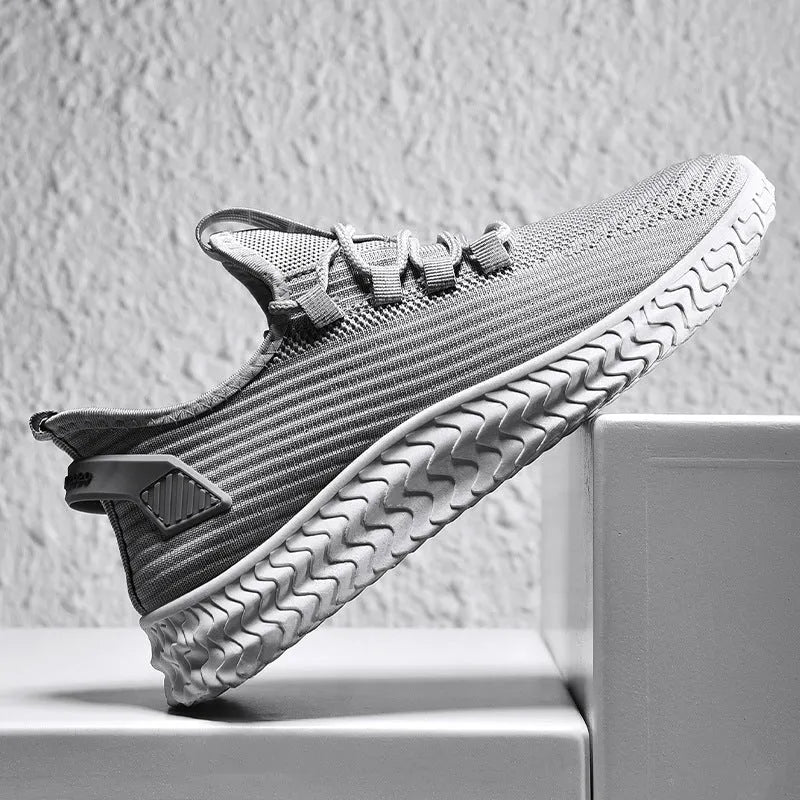 Men's casual shoes with black flying weave upper, rubber sole, and front tie lacing
