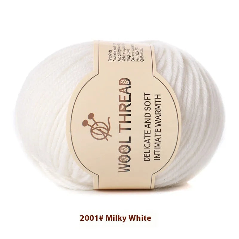 One roll of beige domestic wool hand-knitting yarn for size 10 needles next to knitting needles.